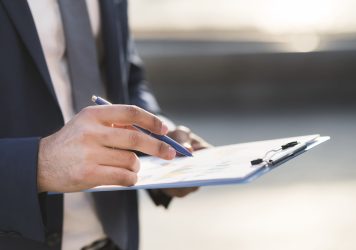 close-up-business-man-checking-clipboard (1)